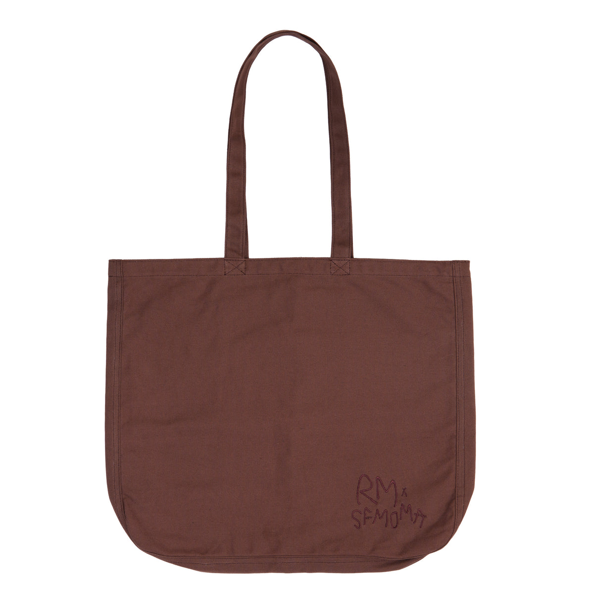 A brown canvas tote bag with two shoulder straps, featuring the text 'BETWEEN YOU AND ME' printed in a dark brown handwritten-style font on the front, set against a plain white background.