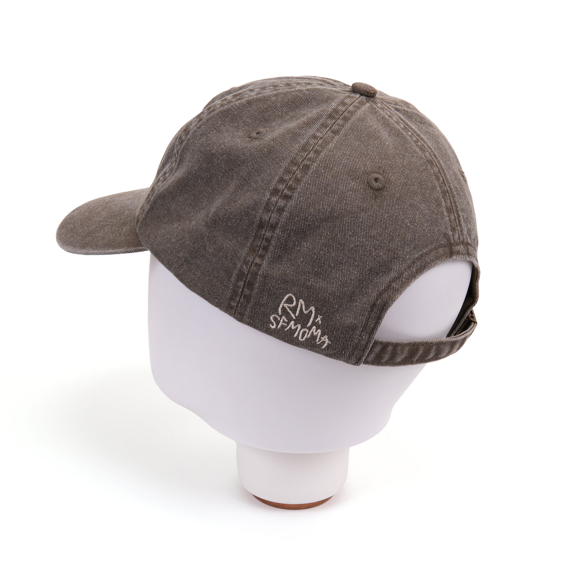 A washed dark brown baseball cap with white embroidered text reading 'BETWEEN YOU AND ME' on the front, shown on a clean white background.