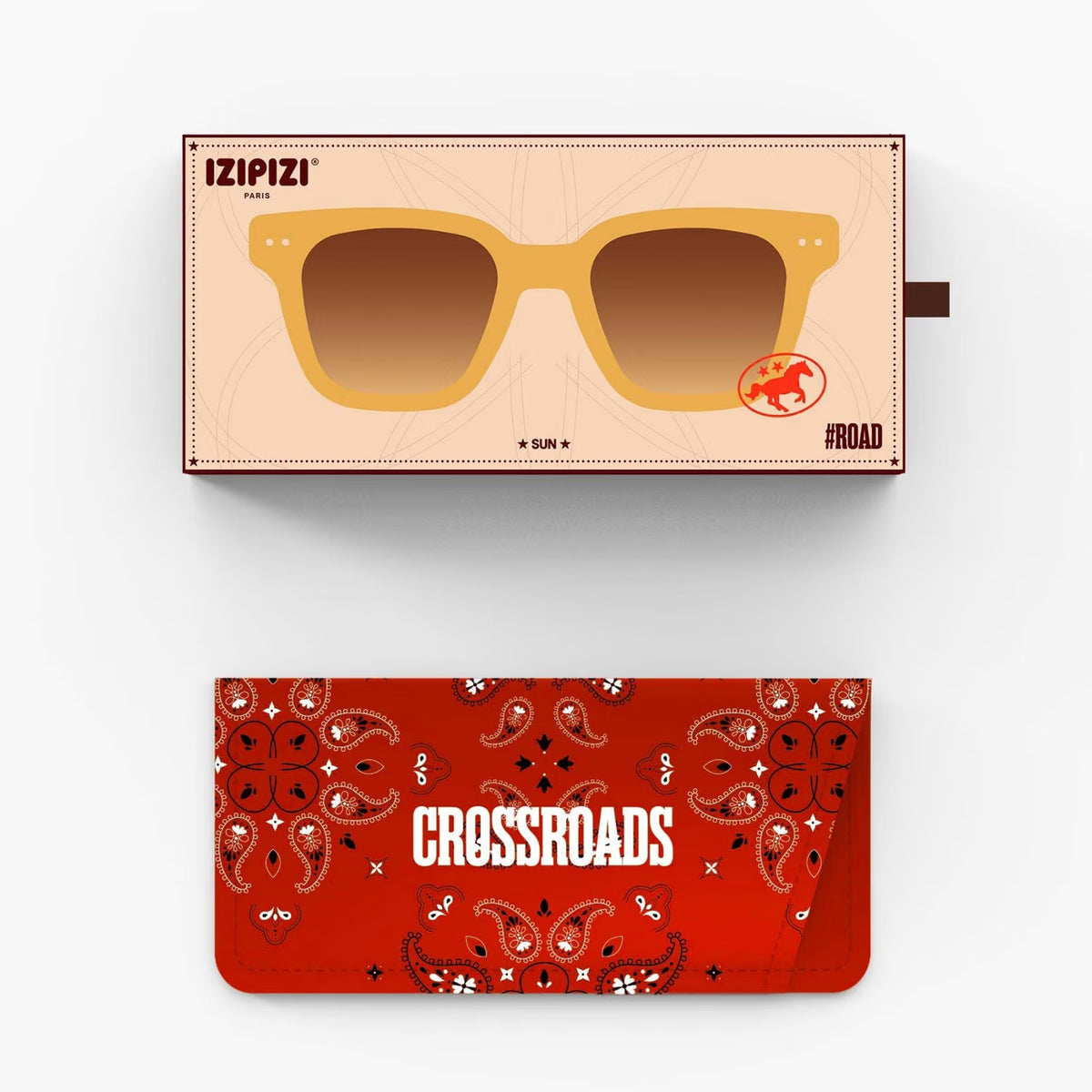 Sunglasses with a beige box featuring Izipizi branding, and a red bandana-style case with 'Crossroads' text.