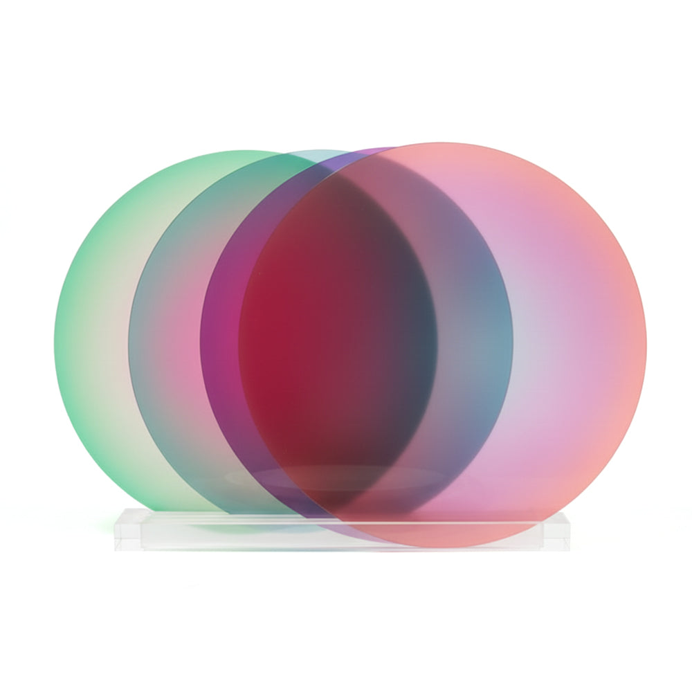 Four circular placemats with gradient colors on a white background