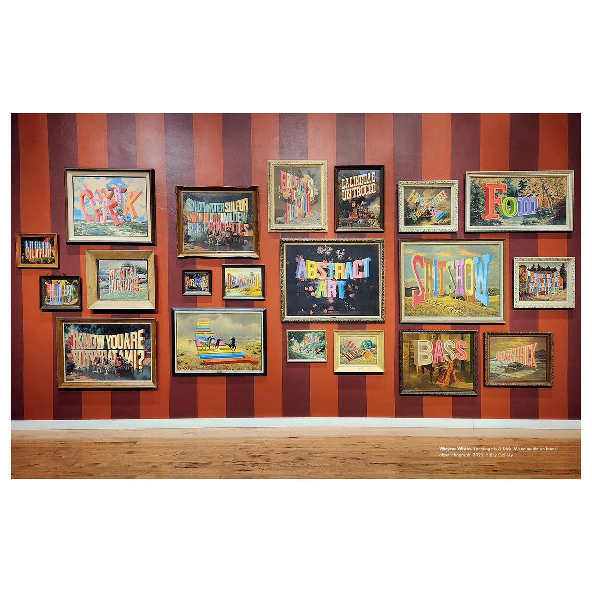A gallery-style wall display of multiple framed abstract and colorful art prints arranged against a red-and-brown striped wall, with a wood floor below.