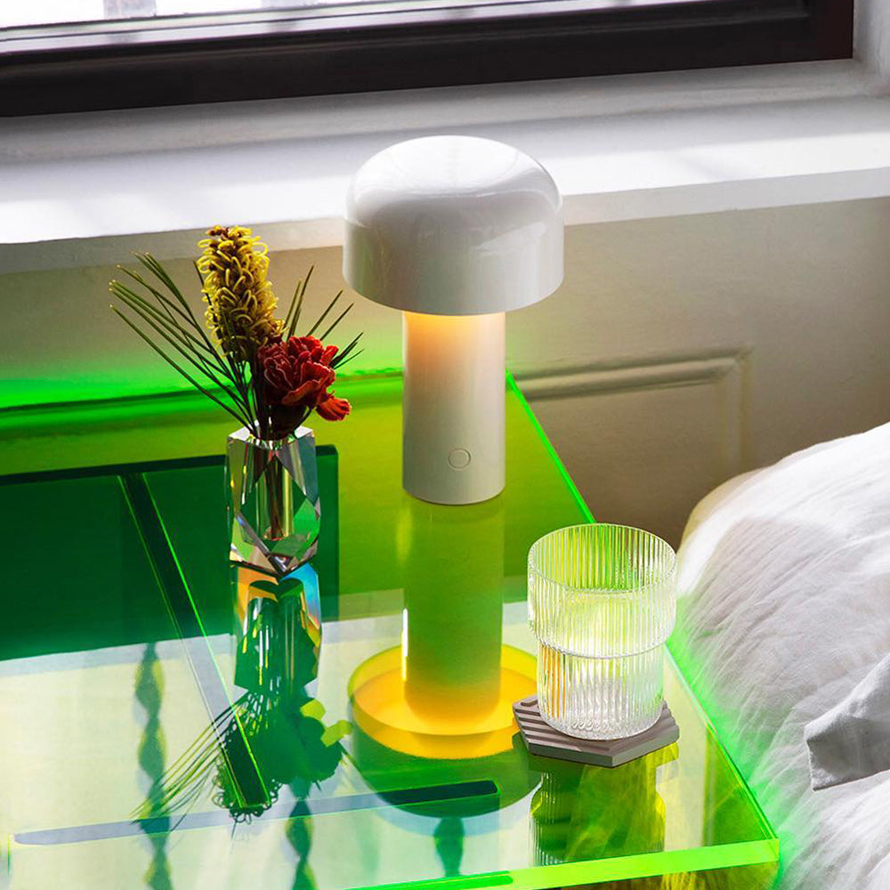 Vase on side table with lamp.