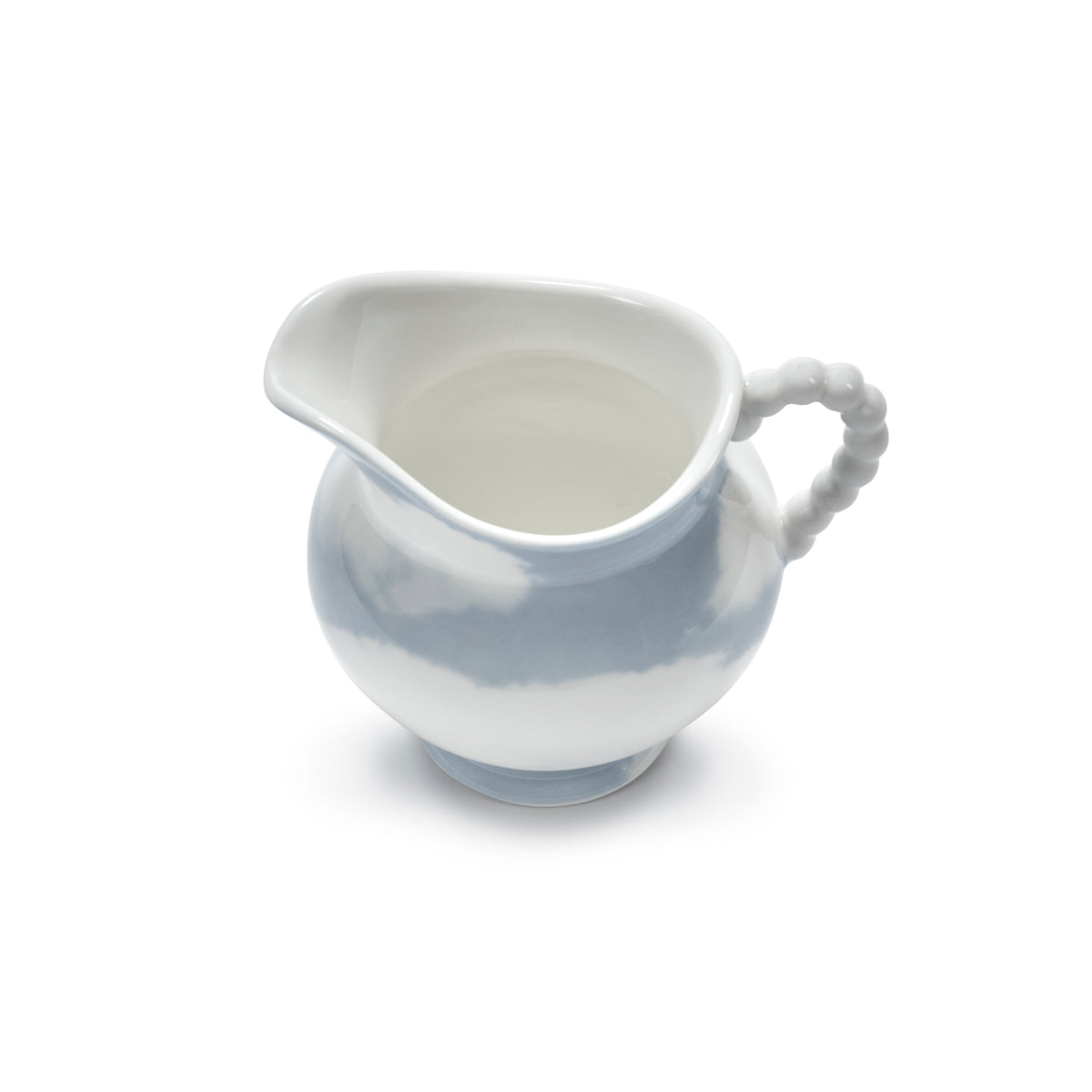 A small porcelain creamer pitcher with a flared spout and a beaded handle, featuring a white and light blue marbled pattern, set against a plain white background.