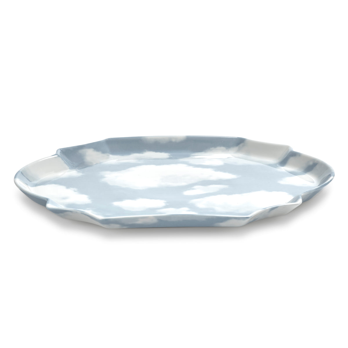 A porcelain plate with a scalloped rim, featuring a sky and cloud pattern in light blue and white, shown on a plain white background.