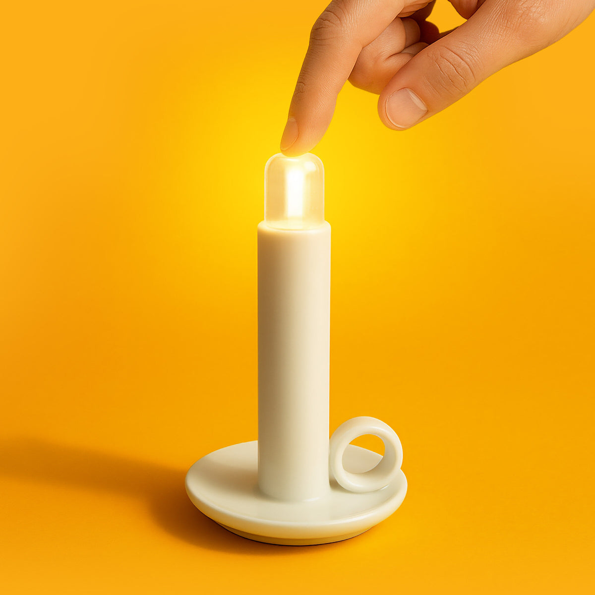 White candle holder with a lit candle on an orange background
