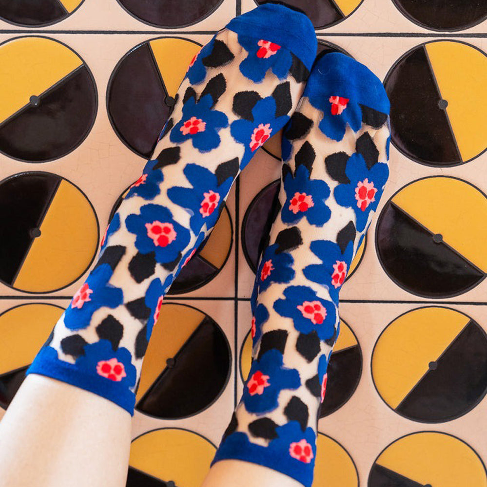 Lifestyle image of Bold Blue Floral Sheer Crew Socks on feet.