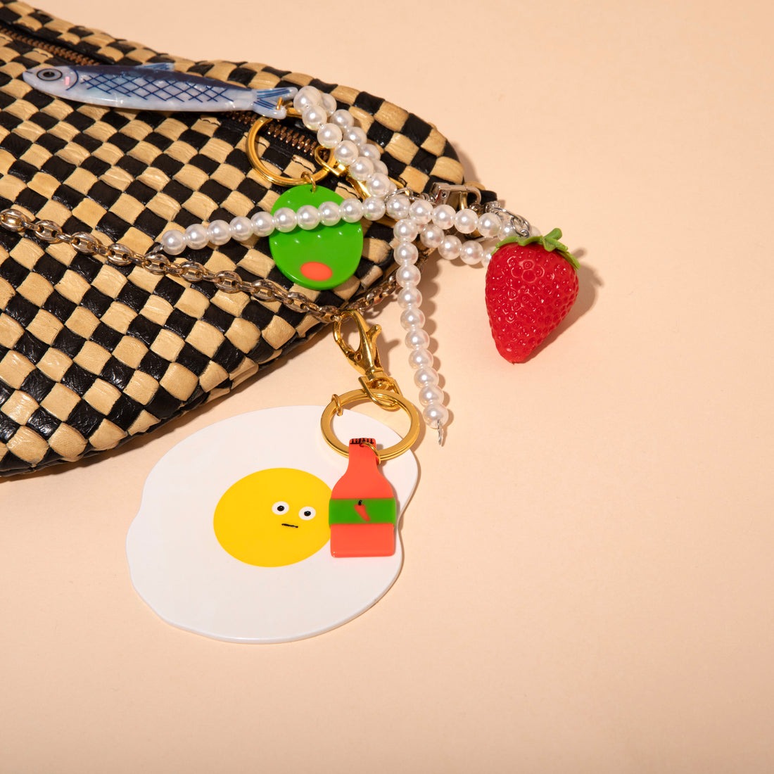 Keychain with a smiley face egg design on a white background
