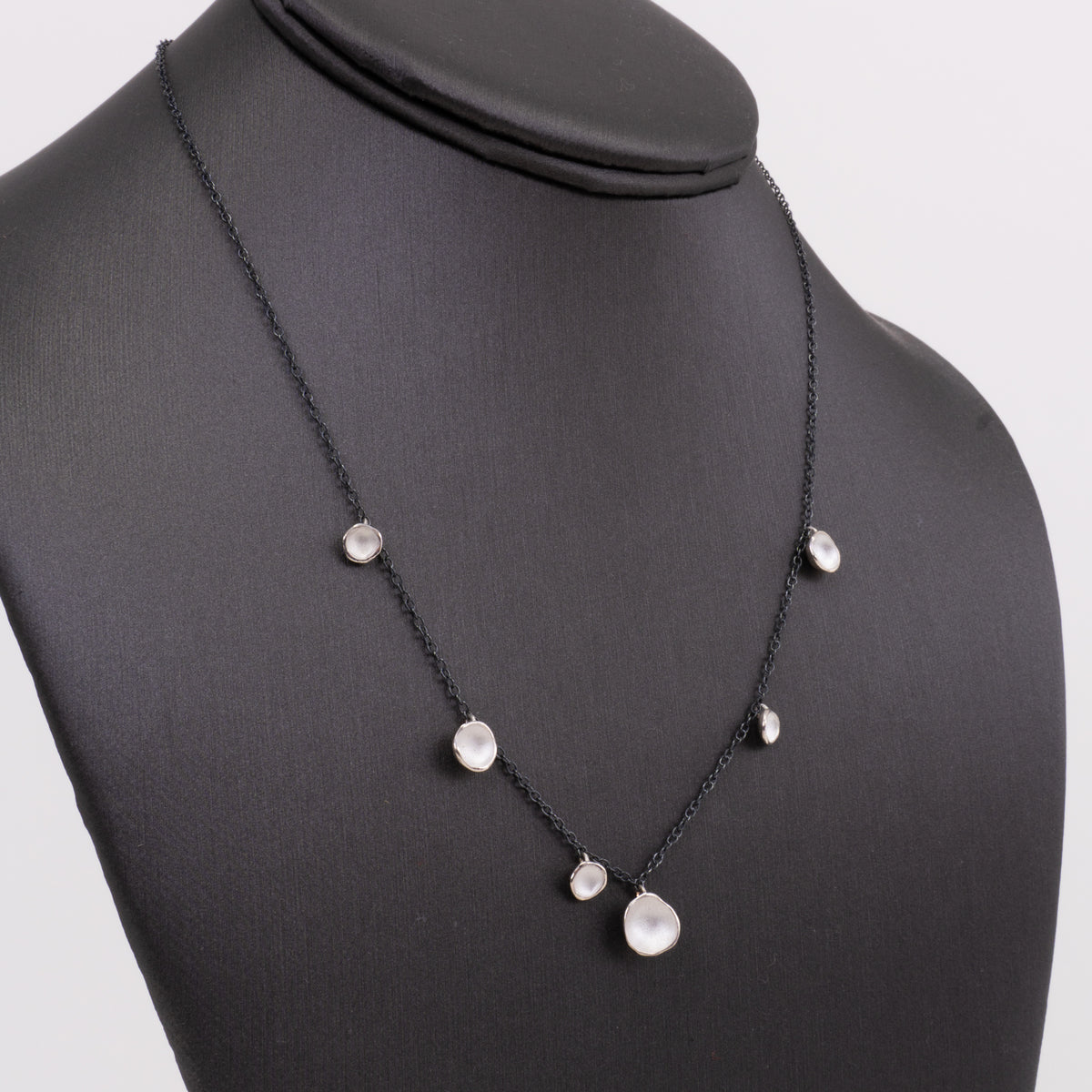 6-Pod Drop Necklace: Sterling and Oxidized Sterling on a dark form