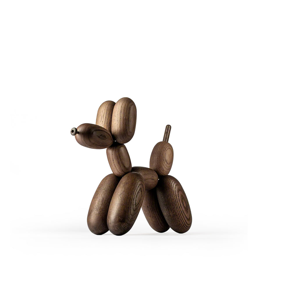 Wooden balloon dog sculpture on a white background