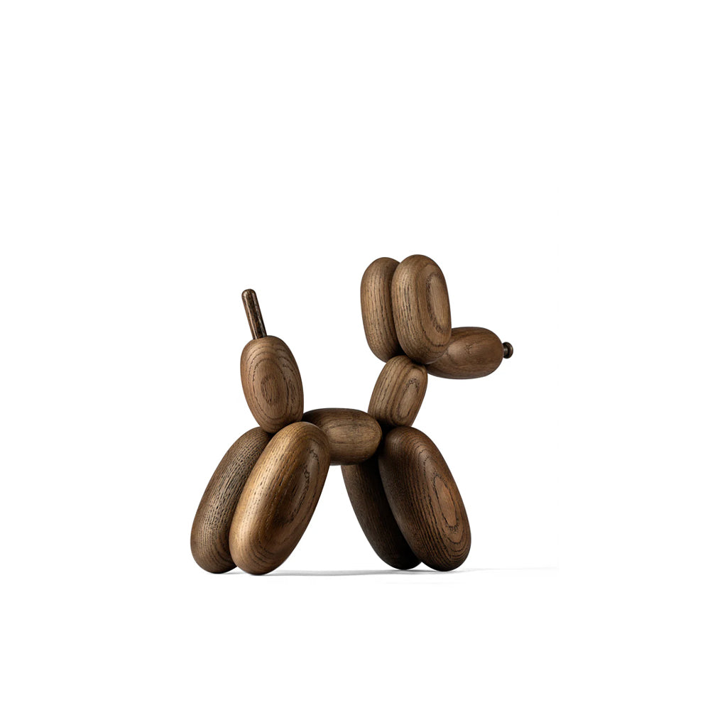 Wooden balloon dog sculpture on a white background