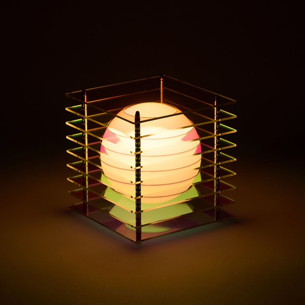 Decorative lamp with a geometric metal frame on a dark background