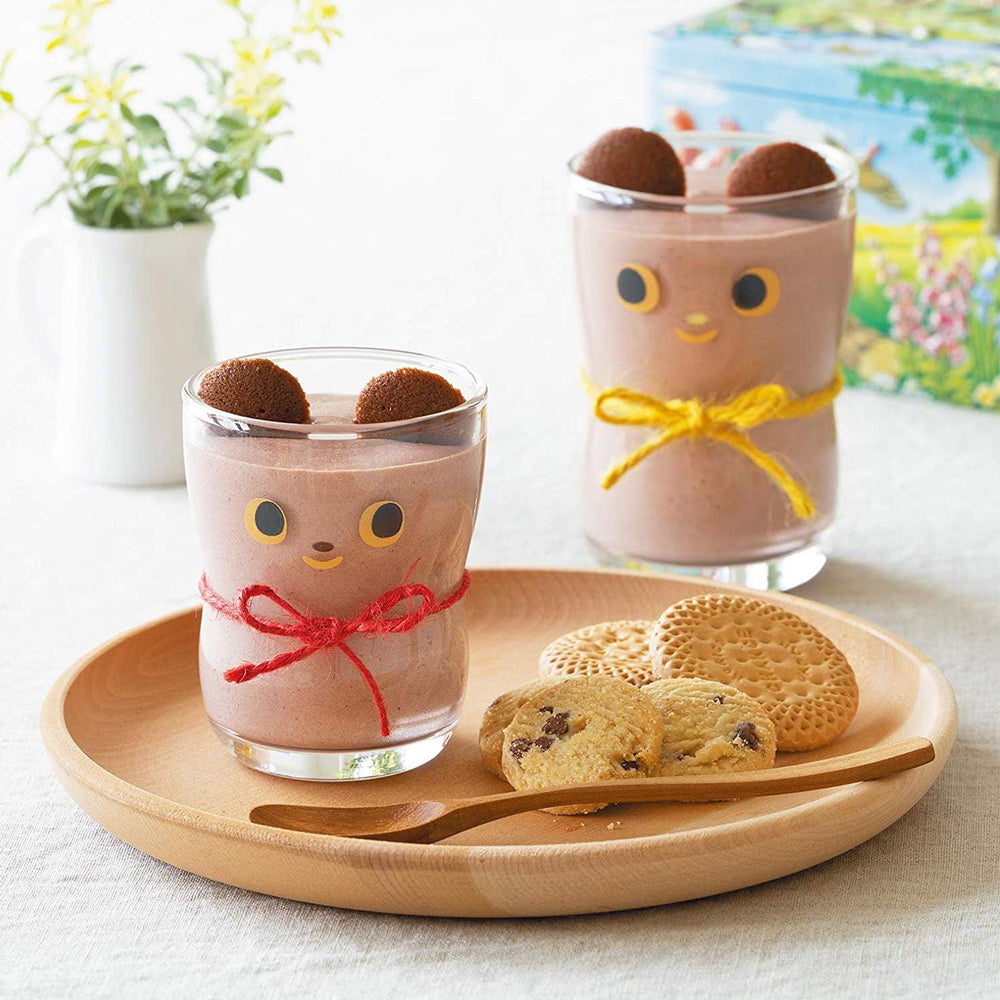 Glass filled with chocolate milk and cookies.