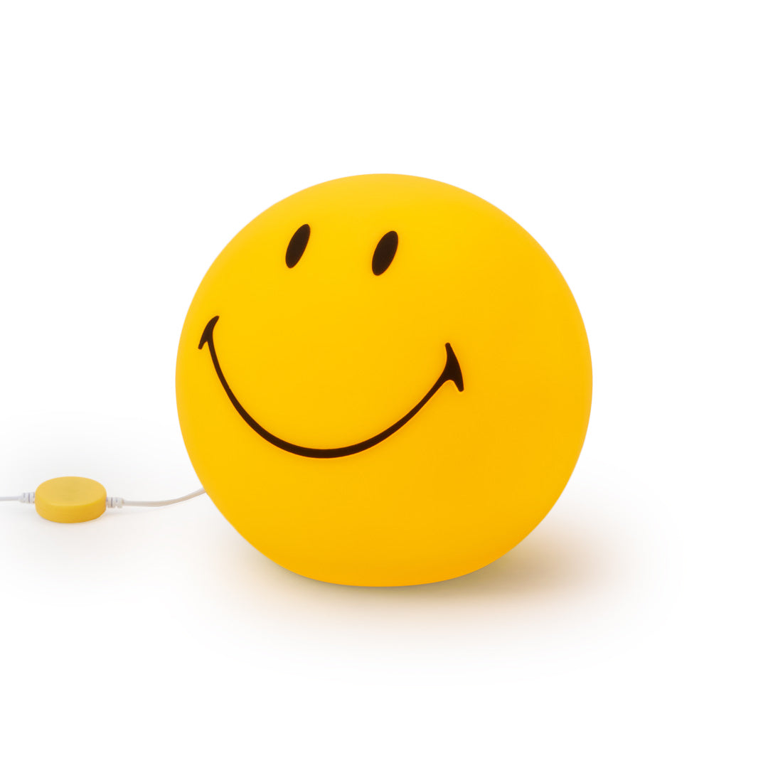 Yellow smiley face ball with a string on a white background