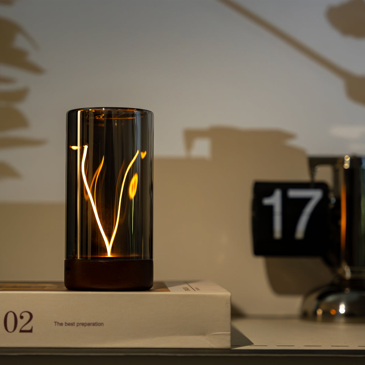 Glass light with illuminated design on a surface with a blurred background