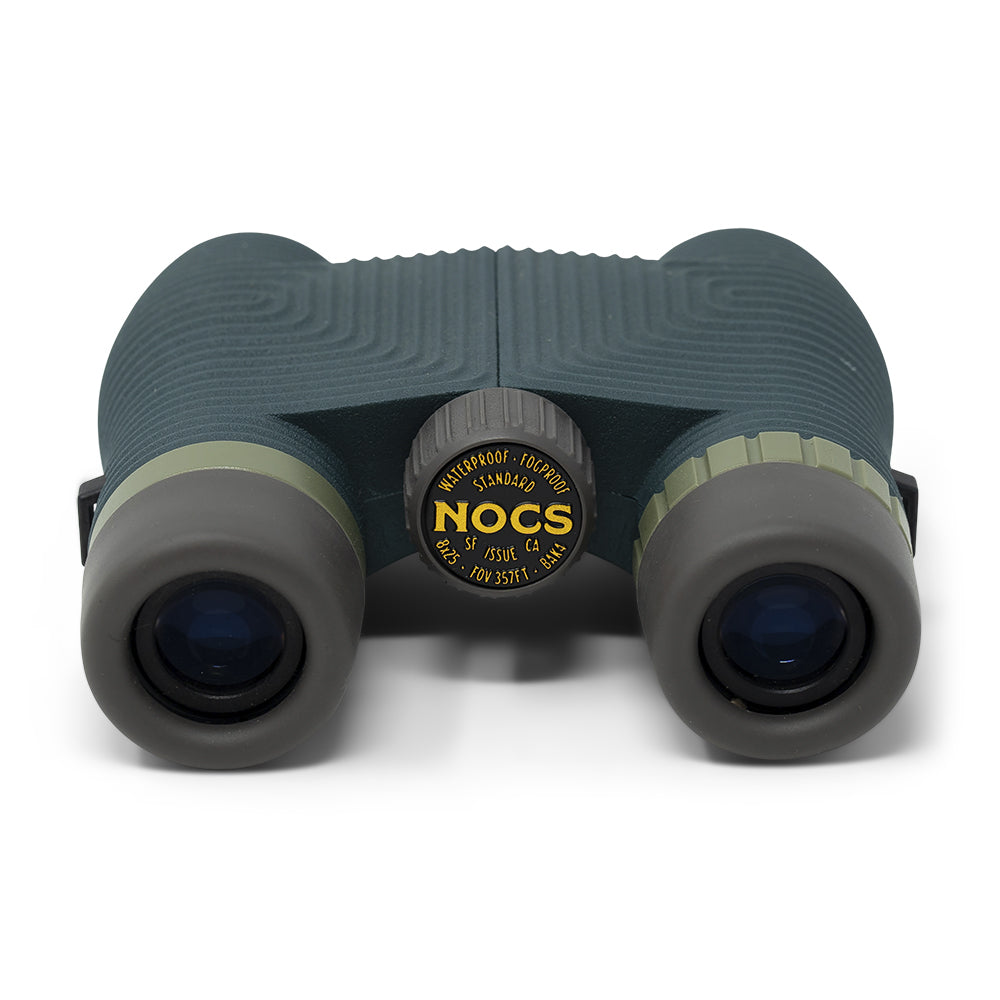 Green binoculars with NOCS logo on a white background