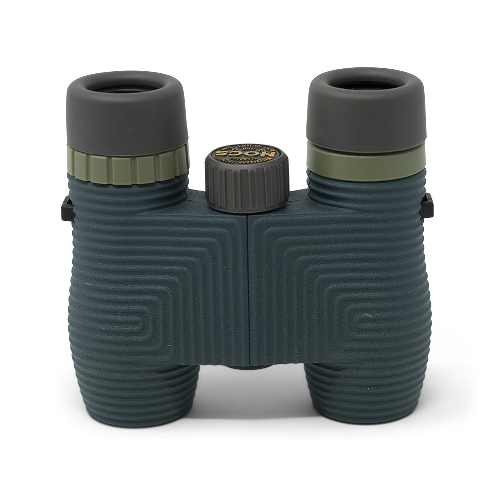 Green binoculars with a white background