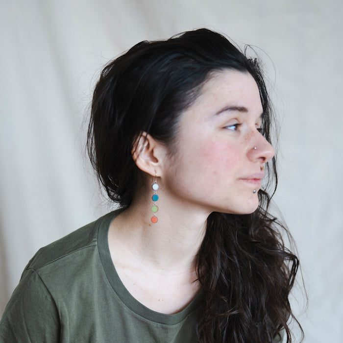 Colorful circular earrings on a white background