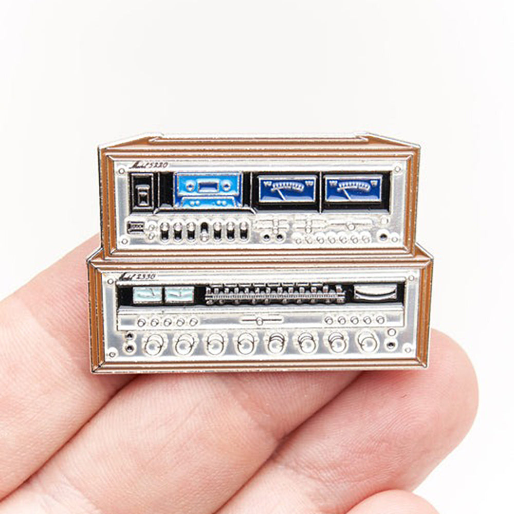 Hand holding Stereo Stack Vintage Receiver Pin.