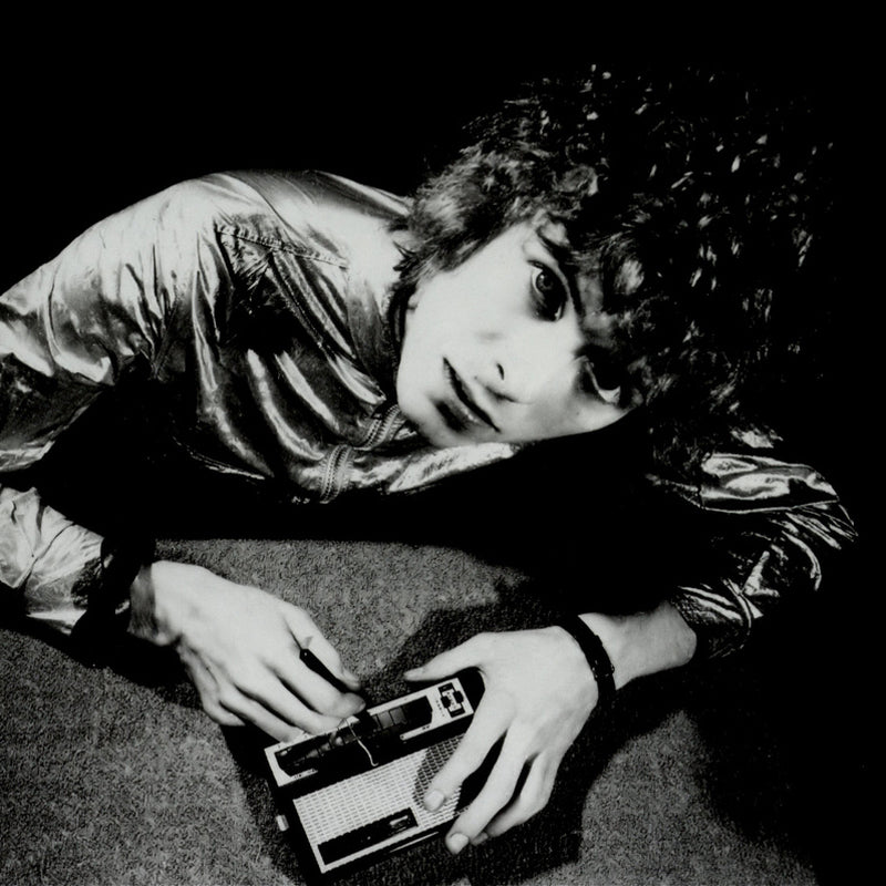 Person holding a vintage sythesizer in a black and white photo