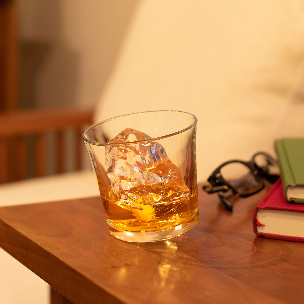Glass of whiskey and ice lifestyle photo.