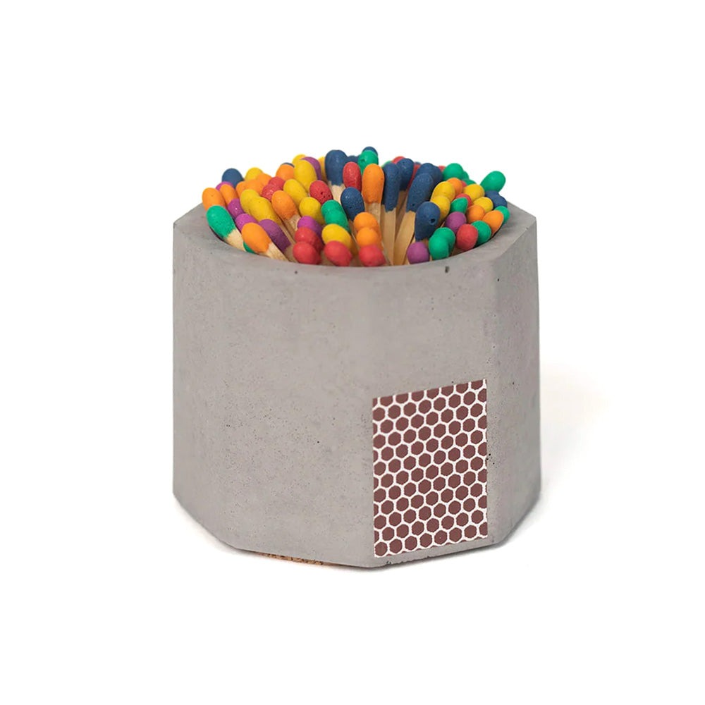 Small concrete match holder and striker, with rainbow matches inside.