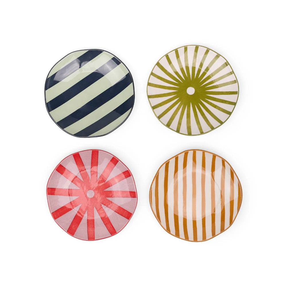 Four colorful small ceramic plates with striped patterns on a white background