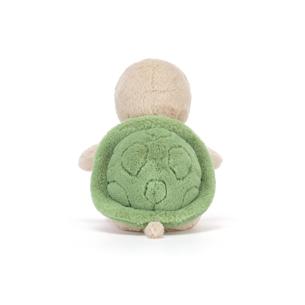 Plush turtle toy with green shell on a white background