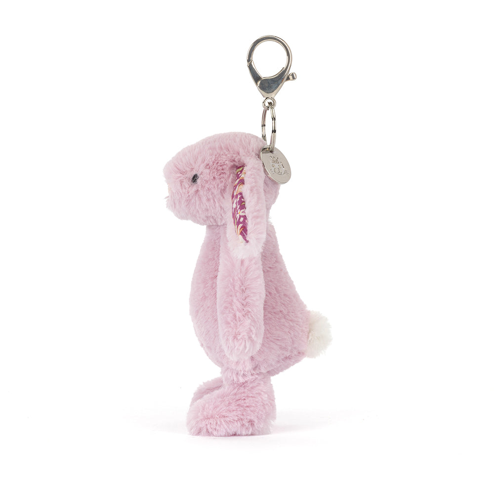 Pastel purple plush bunny keychain with floral ears on a white background