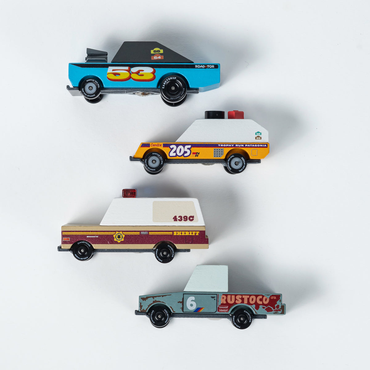 Four toy cars with different designs and numbers on a white background