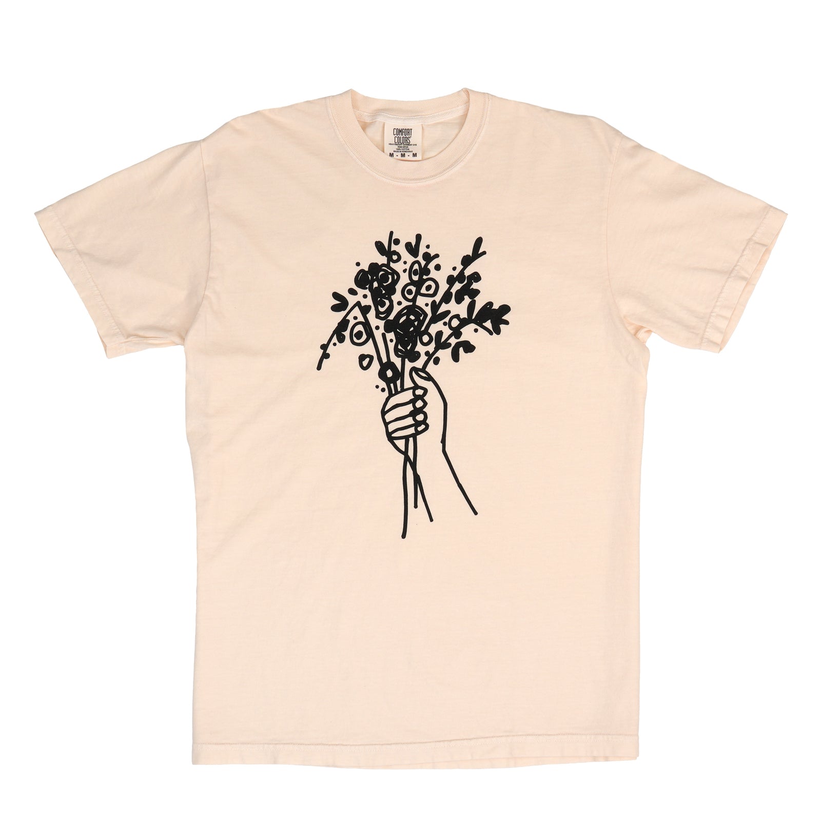 A light beige crewneck t-shirt featuring a black line art graphic of a hand holding a bouquet of flowers on the front, displayed flat against a white background.