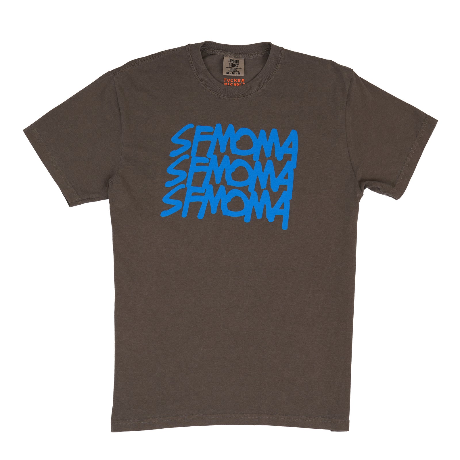 A dark gray short-sleeve crewneck t-shirt featuring the word 'SFMOMA' printed in a bright blue stylized stacked graphic on the chest, displayed flat against a white background.
