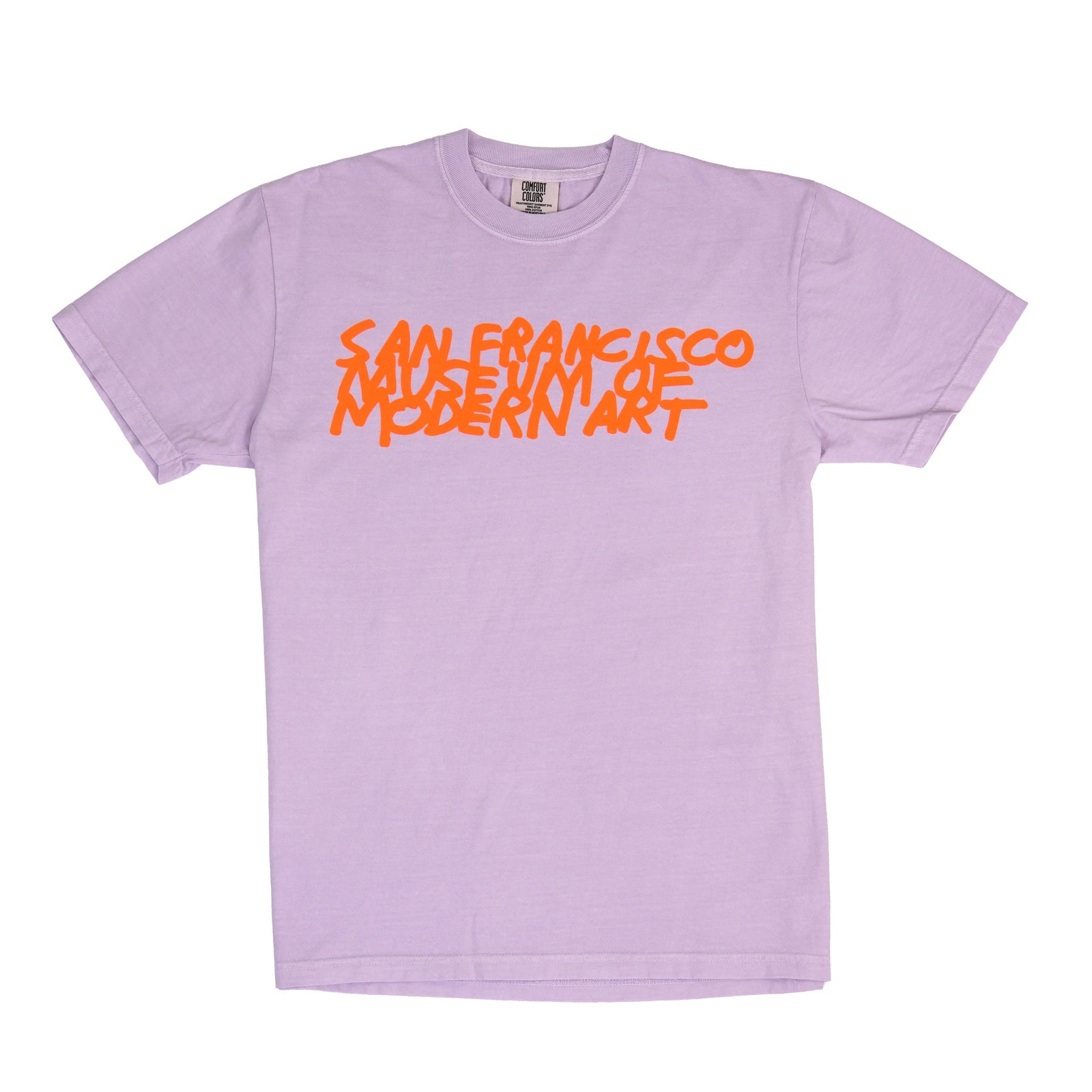 A light purple crewneck t-shirt featuring the text 'SAN FRANCISCO MODERN ART' printed across the chest in a bold, orange graffiti-style font, displayed flat against a white background.