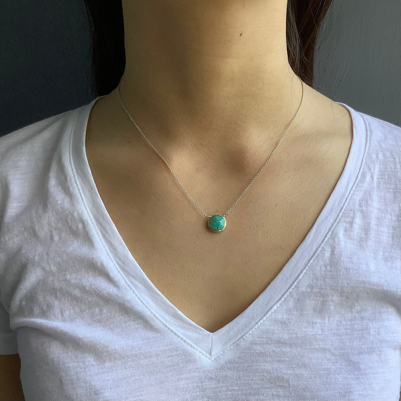 Necklace with a turquoise pendant on a white background