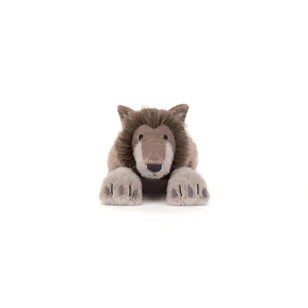 A plush stuffed animal of a brown and beige wolf or wild cat, lying down with its front paws extended, photographed against a seamless white background.