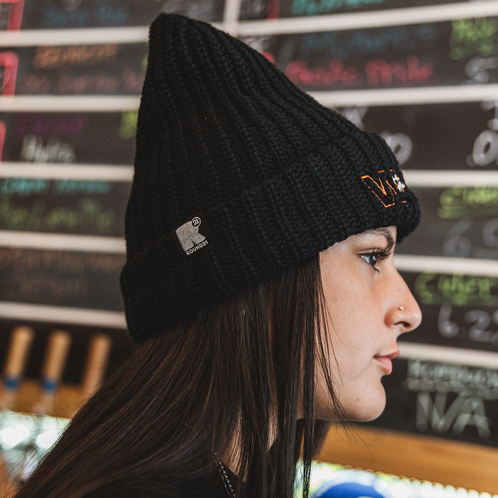 Side view; model wearing beanie.