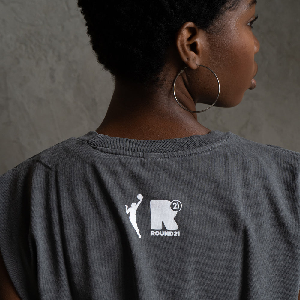 Close-up view; model wearing tee.