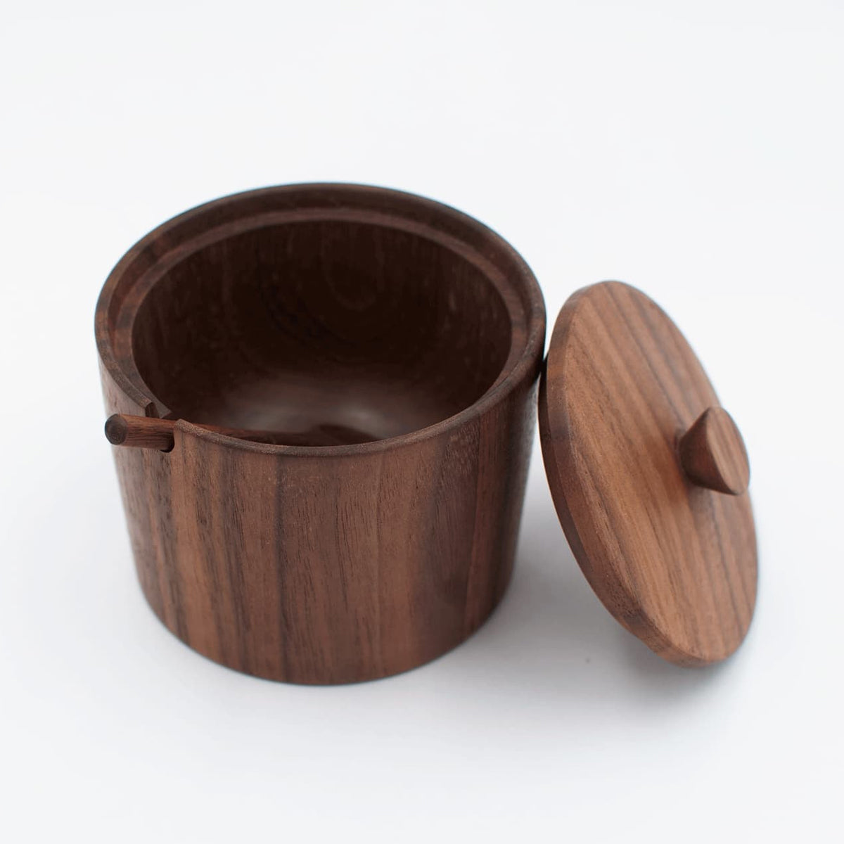 Wooden container with a lid on a white background