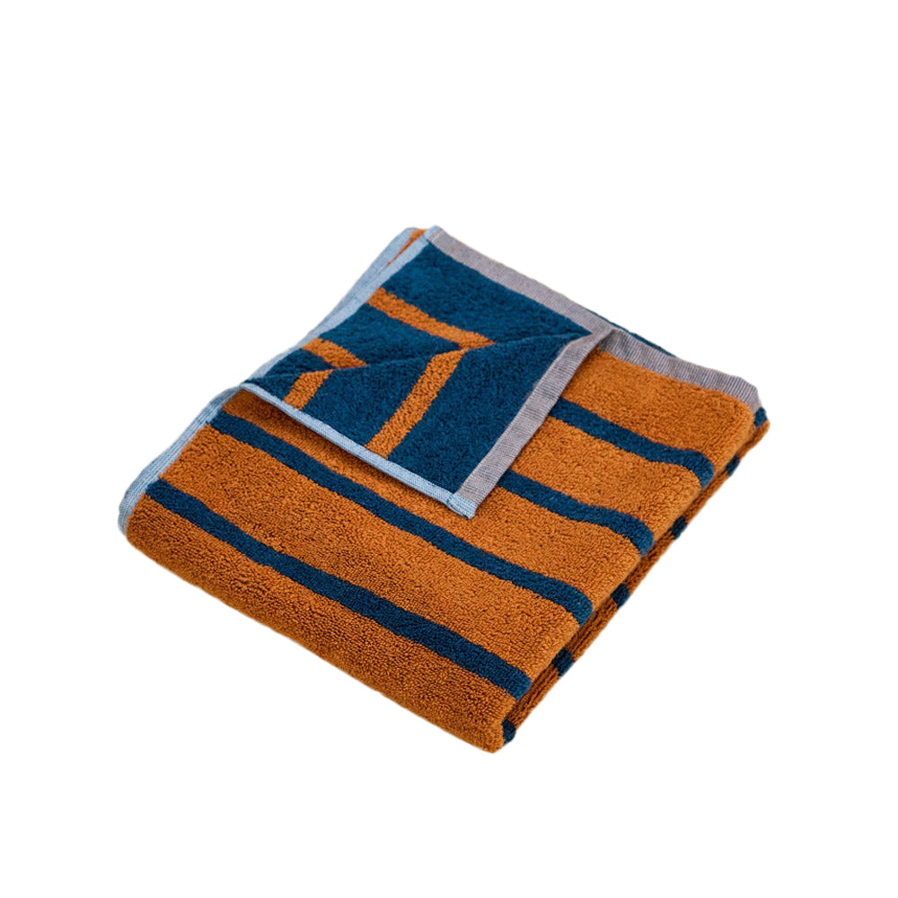 Folded towel with orange and blue pattern on a white background