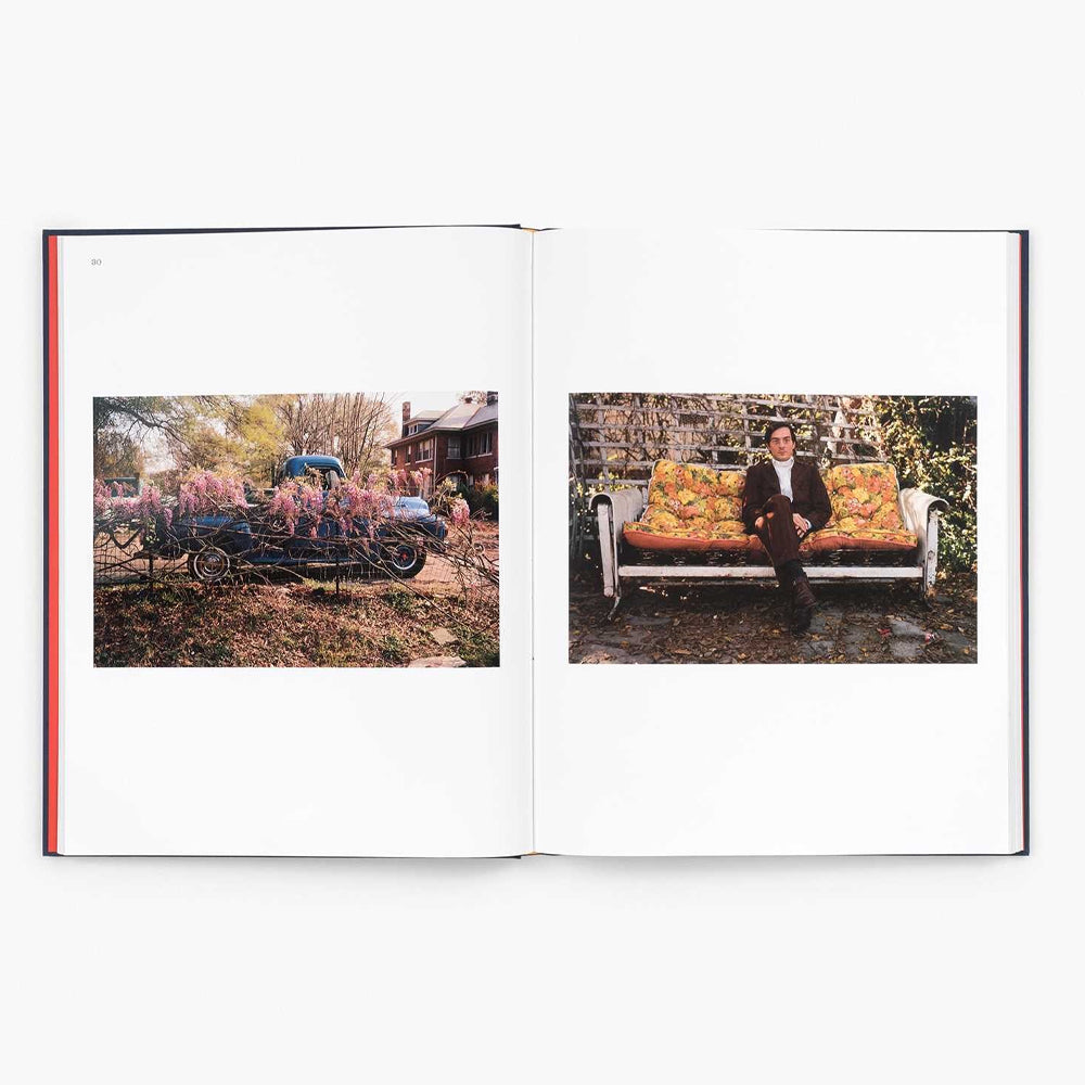 Open book showing two photographs: one of a person on a bench and another of a car with flowers.