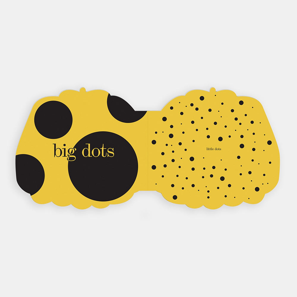 A yellow and black interior spread with the words 'big dots' printed on it, shown on a light gray background.