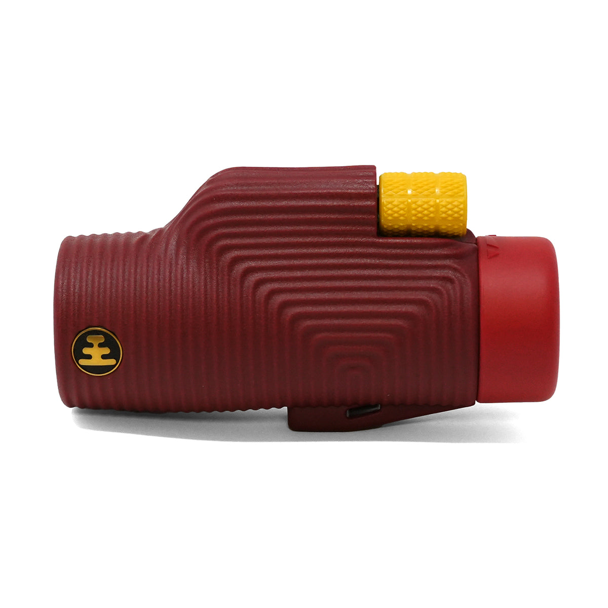 A red monocular with a ribbed textured body, a yellow textured adjustment knob, and a gold circular logo on the side, set against a plain white background.