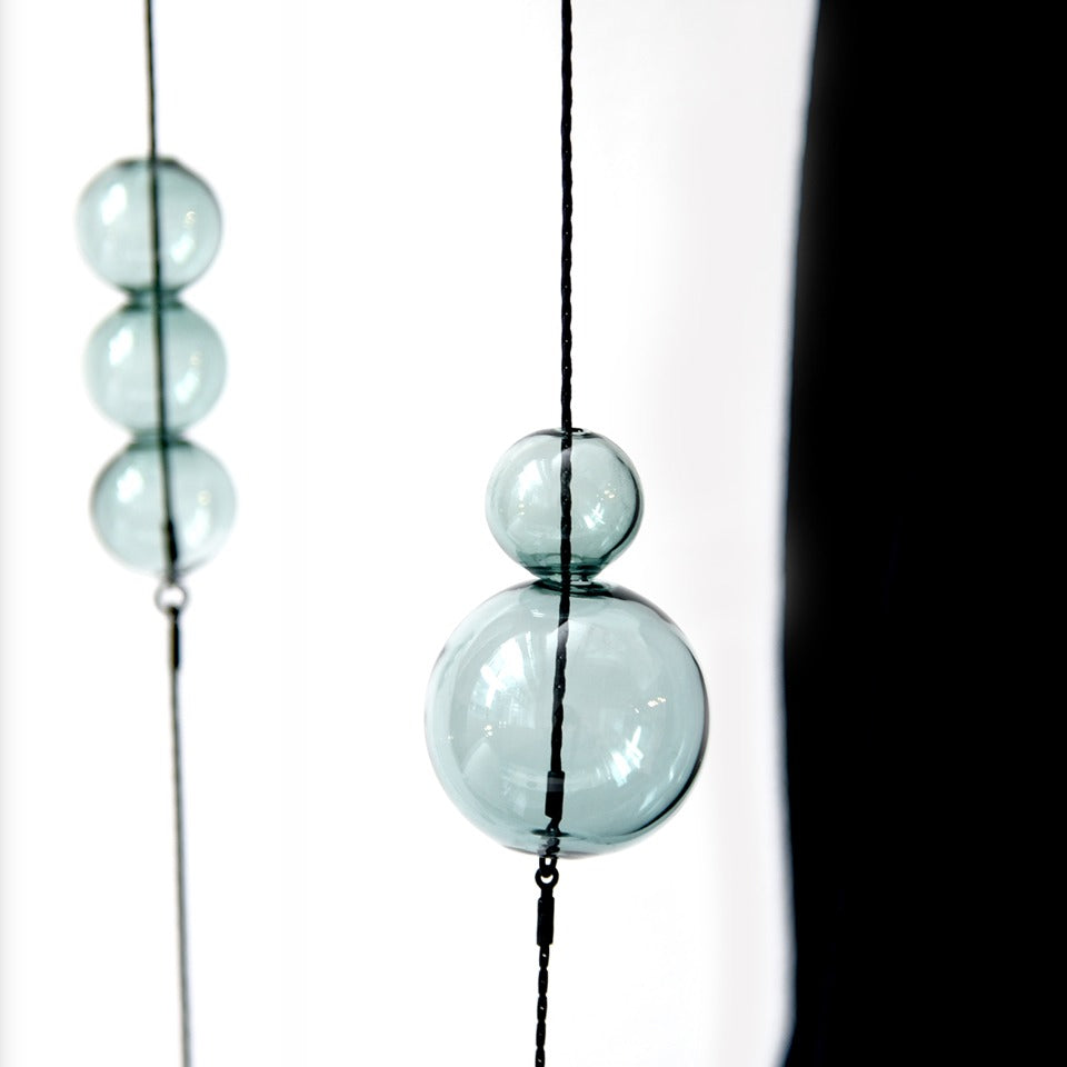 Close-up view of glass balls on necklace.