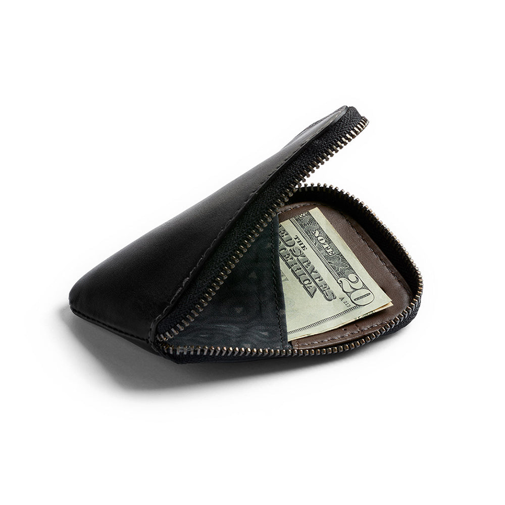Unzipped card pocket with cash inside.