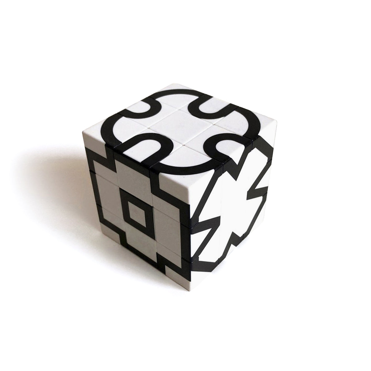 A 3x3 twisty puzzle cube with a black and white geometric design, shown on a clean white background with a soft shadow.