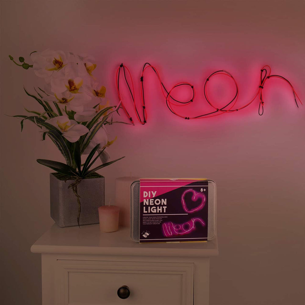 Neon light on wall with packaging on side table.