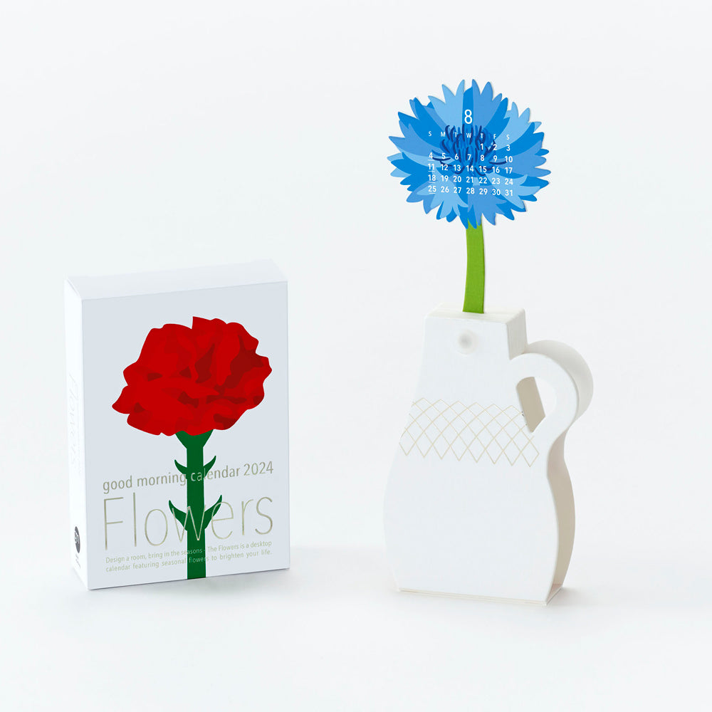Packaging next to assembled flower in vase.