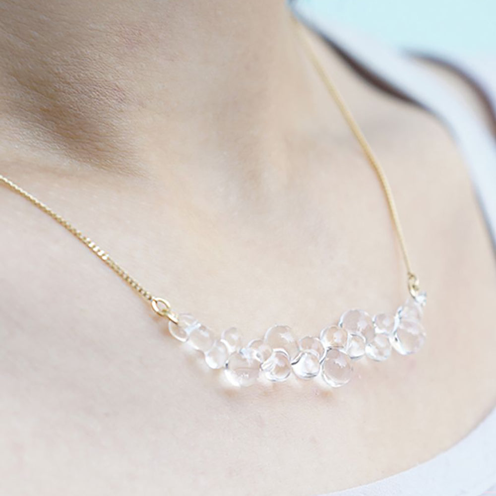 Close- view model wearing necklace.