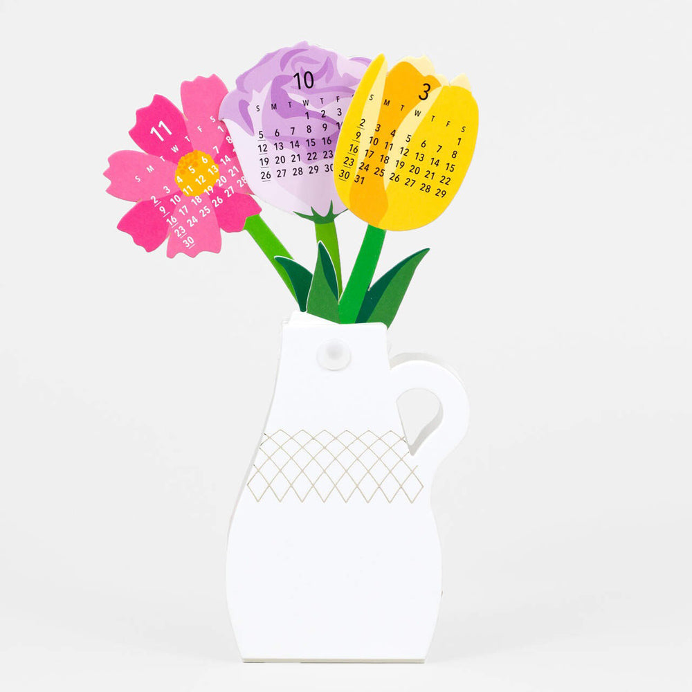 Paper flower cut outs with month grid, in a paper vase.