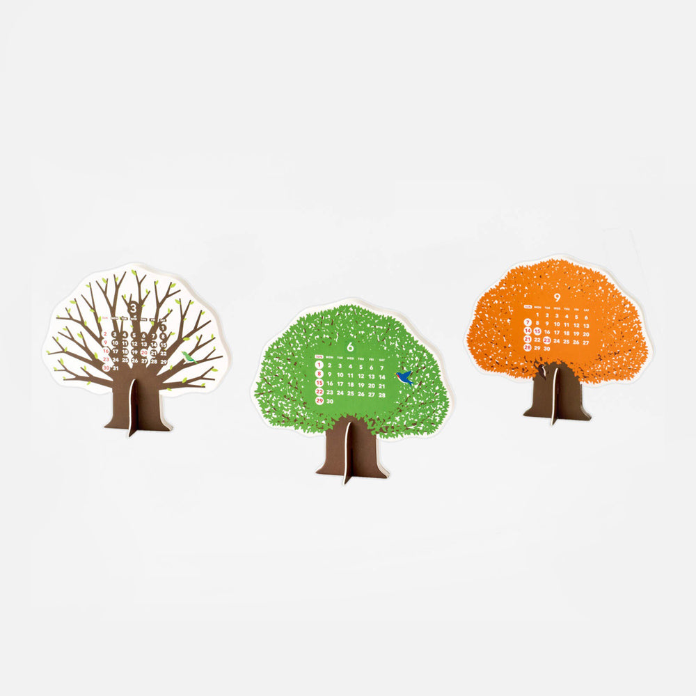 Paper cut out of trees with printed month grid.