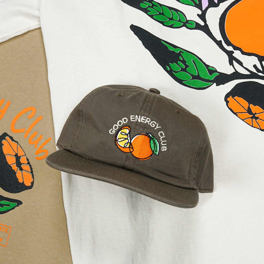 Lifestyle image of Good Energy Club hat and shirt.